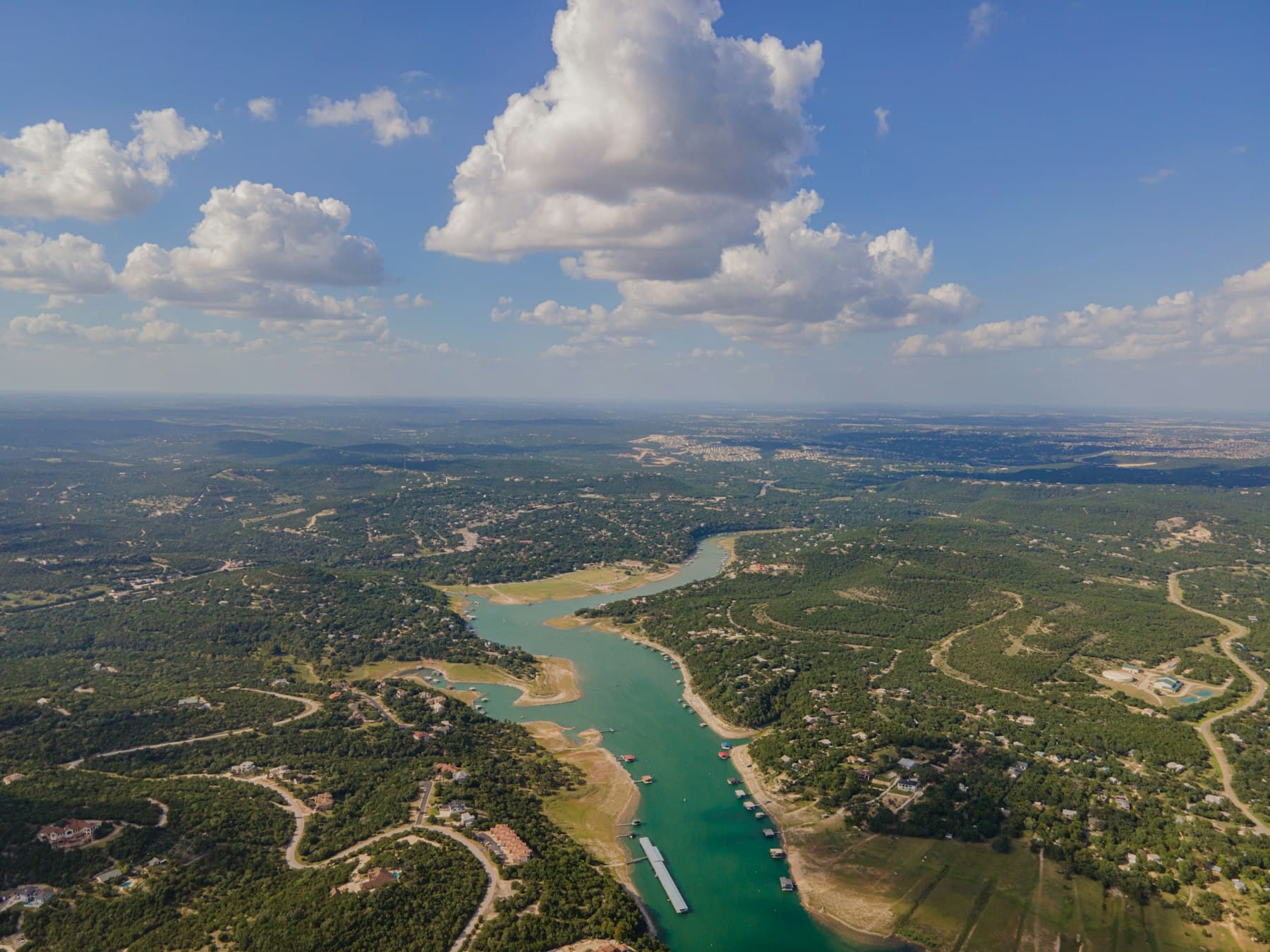 Commercial real estate in Texas — Aerial view of green field and body of water during daytime